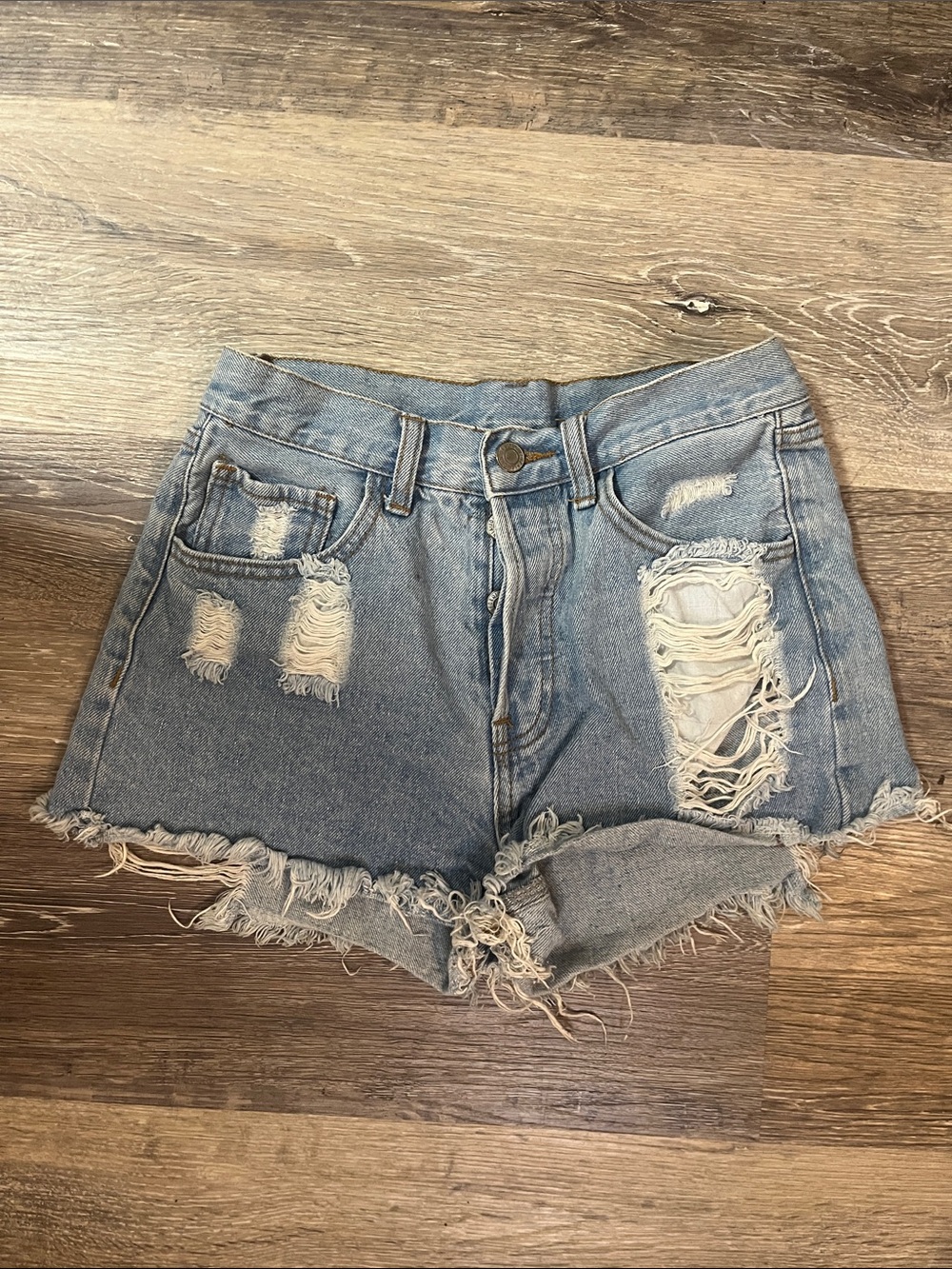 High-Rise Distressed Denim Shorts in Light Blue